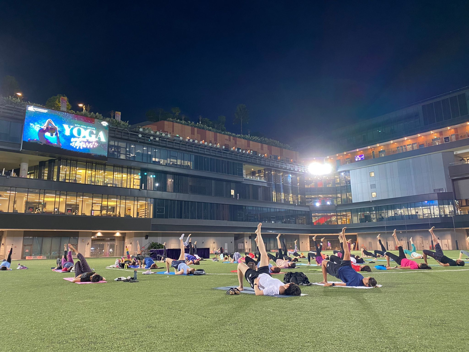 Colleagues enjoying a gentle outdoor stretch session on a rooftop garden